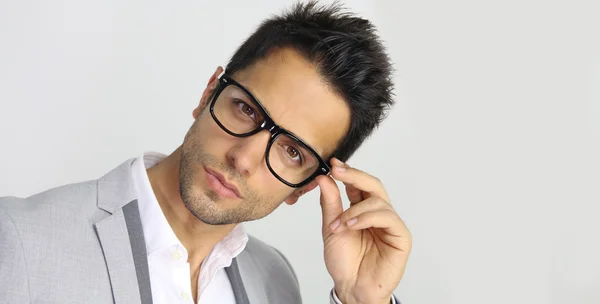 Handsome man holding eyeglasses — Stock Photo, Image