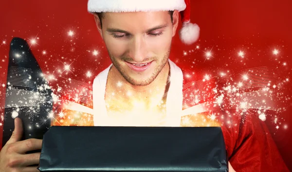 Young man opens a  gift — Stock Photo, Image