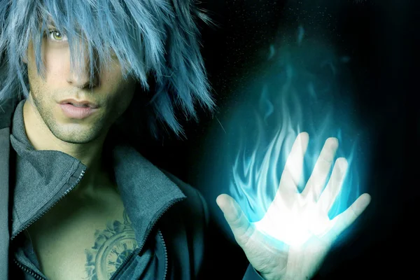 Handsome sorcerer that creates a fireball — Stock Photo, Image