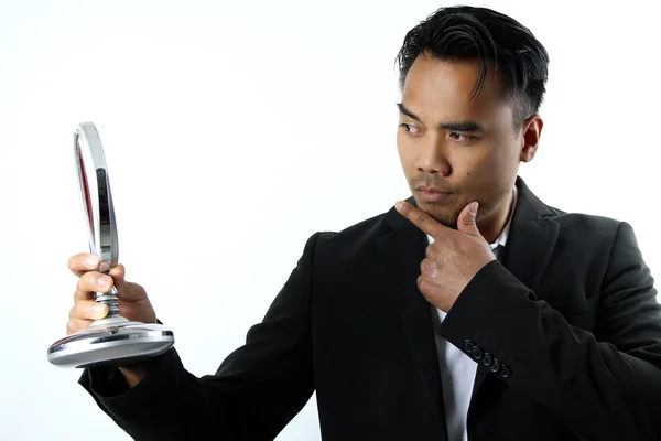 Asian man who admires in the mirror — Stock Photo, Image