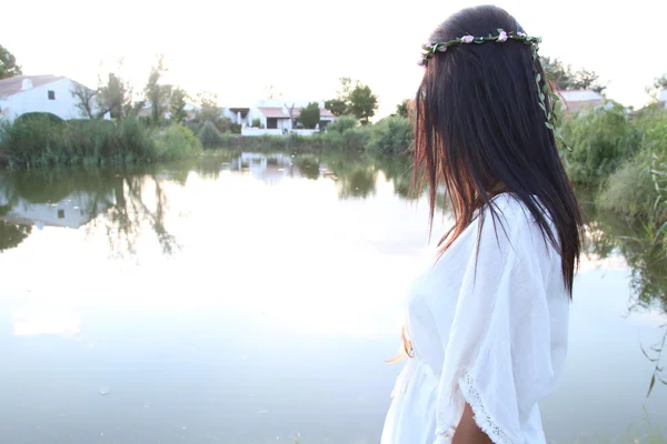 Young female next to a pond — Stock Photo, Image