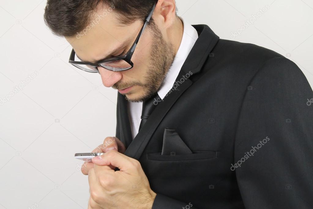 young businessman calling discreetly