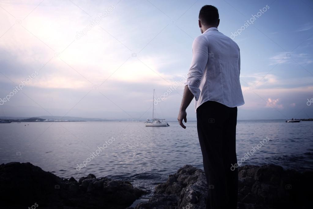 Young man in front of the sea