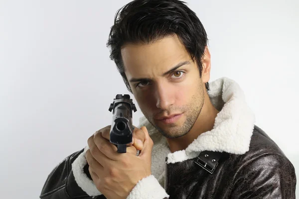 Handsome guy holding a gun — Stock Photo, Image