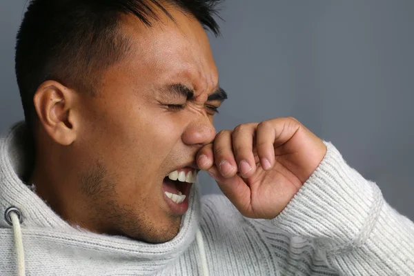 Young man sneezing — Stock Photo, Image