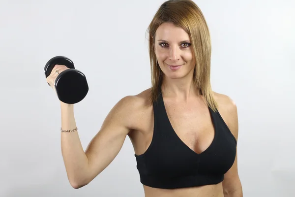 Fitness girl - woman holding a dumbbell — Stock Photo, Image