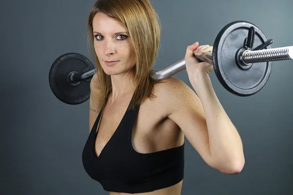 Young woman doing weight training — Stock Photo, Image