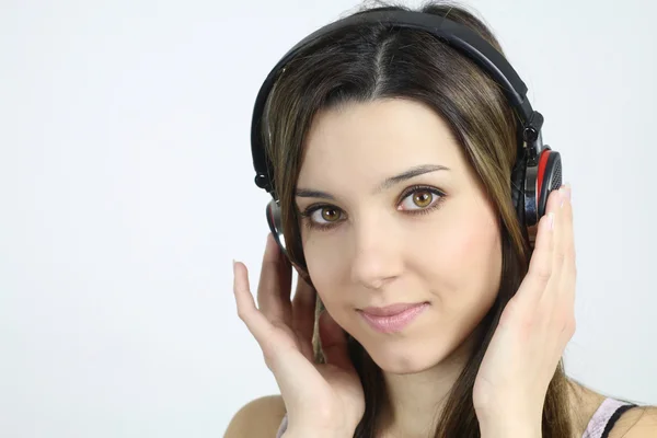 Beautiful woman listening to music with a headphones — Stock Photo, Image