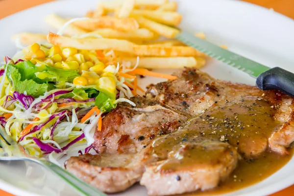 Juicy grilled pork chop (neck cut) with salad — Stock Photo, Image