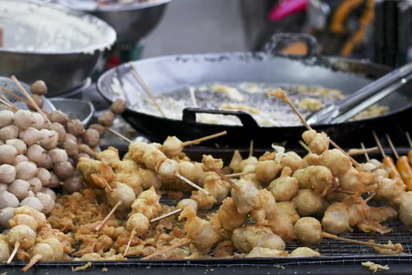 Skewered fried meat and balls on sticks, asian street food — Stock Photo, Image