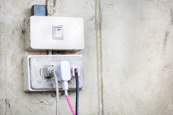 Old switch and plug on the wall of home office. — Stock Photo, Image