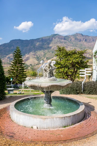 Old fountain in the park on a background of mountains — Stock Photo, Image