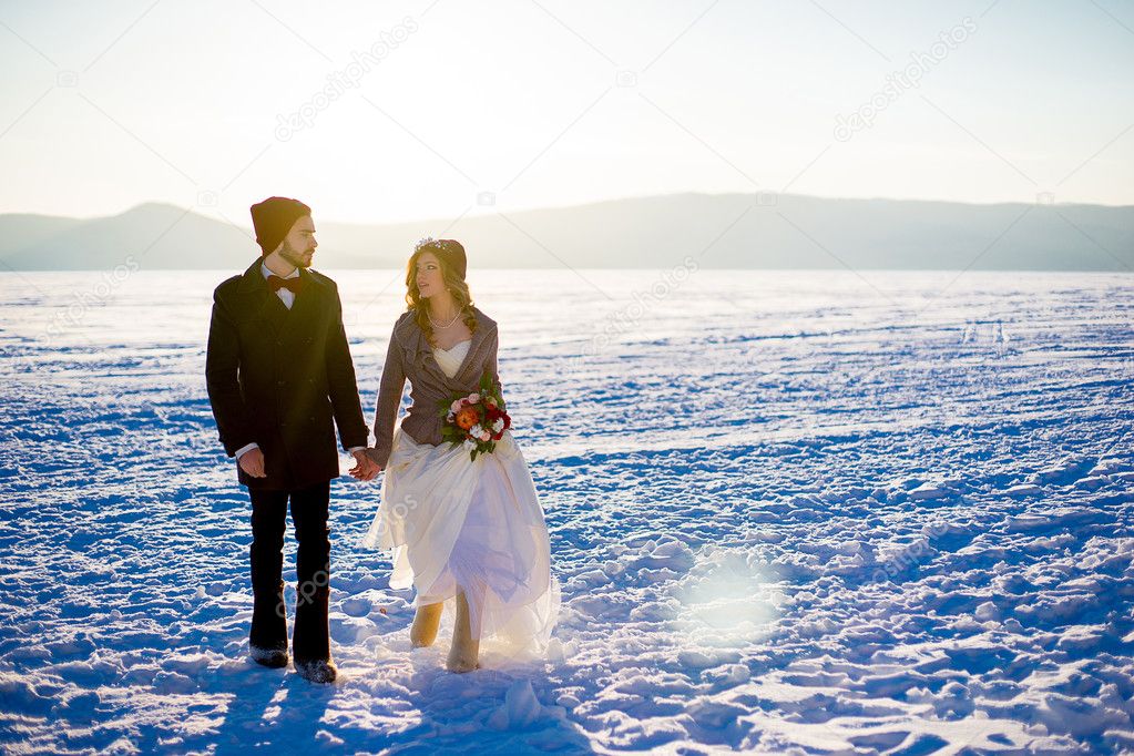 groom with the bride in the winter