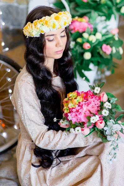 Girl with black hair on the background of flowers — Stock Photo, Image
