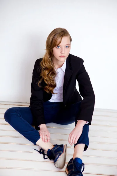 The girl in a jacket on a beige background — Stock Photo, Image