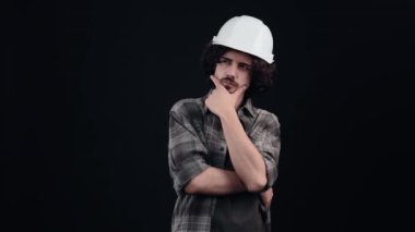 Kafasına özel bir kask takmış, ekose gömlek giymiş, siyah arka planda, stüdyoda...,