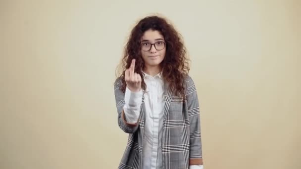İsyan eden genç kadın orta parmağını iki eliyle gösteriyor ve ısrarla elini sallayarak odaya bakıyor.. — Stok video