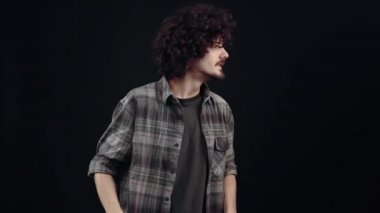 Cheerfully charismatic young man, he raised his fists and joyfully shouted a sincere wow, being satisfied that he had hit. Isolated on black background, Concept of life. Peoples emotions. 4k portrait