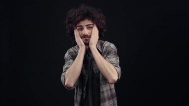 The charismatic, optimistic young man shows his joy by shouting the word wow cheerfully, then showing a proud look ahead. Isolated on black background, Concept of life. Peoples emotions. 4k portrait