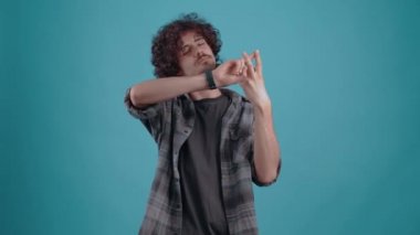The young senior raised his hands, crossed his fingers, displaying makeshift bars. Isolated on black background, Concept of life. Peoples emotions. 4k portrait