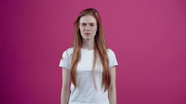 Kızıl saçlı genç kadın kaşlarını çatar ve elini burnuna koyar, kötü kokar. Çilli genç, beyaz tişörtlü, pembe arka planda izole edilmiş. İnsanların yaşam tarzı kavramı