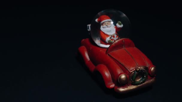 Transport de cadeaux de Noël par le Père Noël dans une petite voiture rouge. Peinture miniature. Le concept des jouets d'hiver — Video