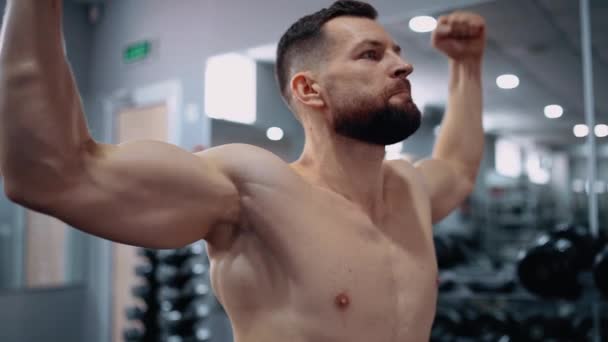 O quadro próximo com o atleta tensionando seus bíceps. Intensa energia masculina. Estilo de vida saudável. Conceito de desporto — Vídeo de Stock