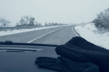 Snowy road from inside a car clipart