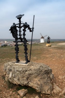 Don Kişot 'un metalik heykeli, Cervantes' in Dulcinea heykeli ve arka planda yel değirmenleri.