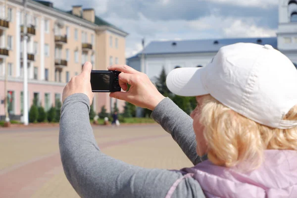 La chica toma fotos del paisaje de la ciudad. Día de San Veronicas Día de los Fotógrafos . — Foto de Stock