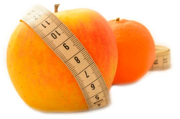 Ripe fruit with a measuring tape diet. — Stock Photo, Image