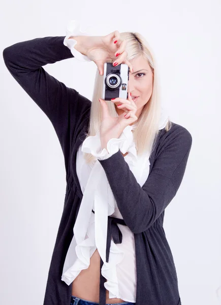 Blonde woman photographing over white background Royalty Free Stock Images
