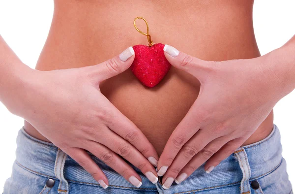 Woman's belly with red heart — Stock Photo, Image