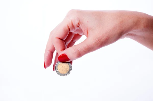 Женская рука с монетой евро — стоковое фото