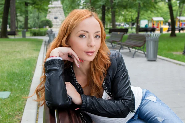 Beautiful blond woman sitting on bench