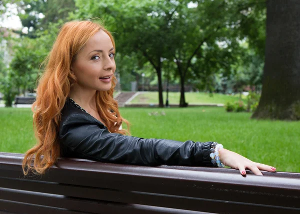 Beautiful blond woman sitting on bench Εικόνα Αρχείου