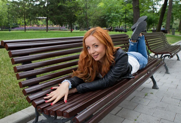 Beautiful blond woman sitting on bench Royalty Free Εικόνες Αρχείου