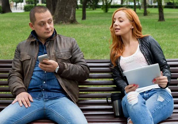 Friends are fun to watch something on a mobile phone and tablet Stock Photo