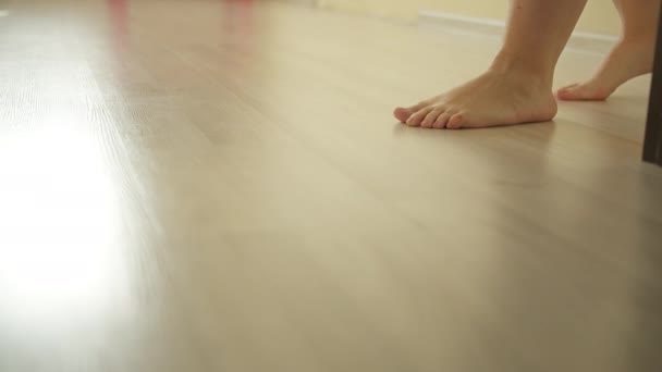 Woman walking naked on the laminate floor indoors — Stock Footage Woman walking naked on the laminate floor indoors Video Clip