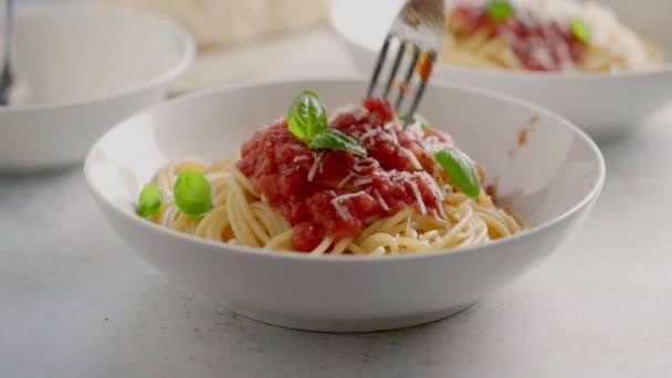 Espaguetis con salsa de tomate y albahaca en un plato — Vídeos de Stock