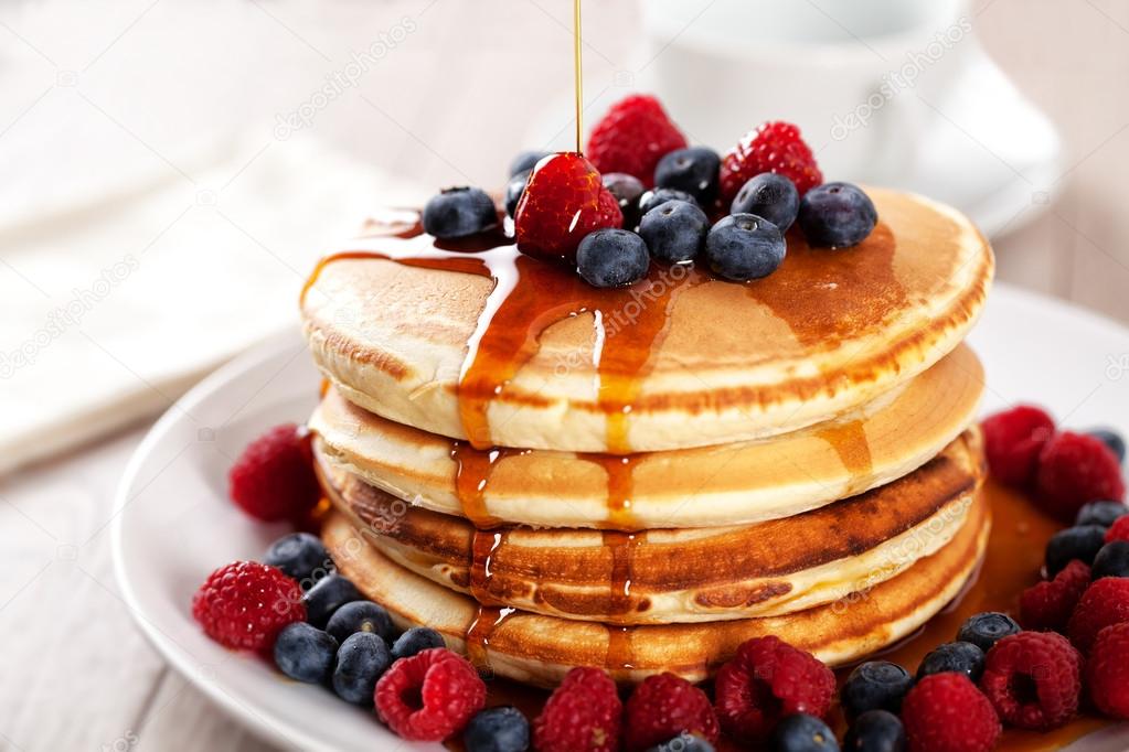 Pancakes with berries and maple syru