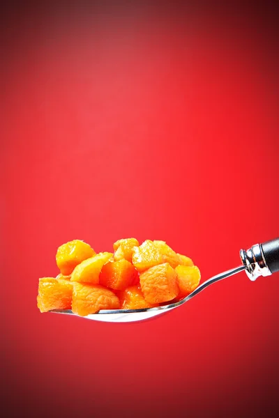 Spoon with apricot pieces — Stock Photo, Image