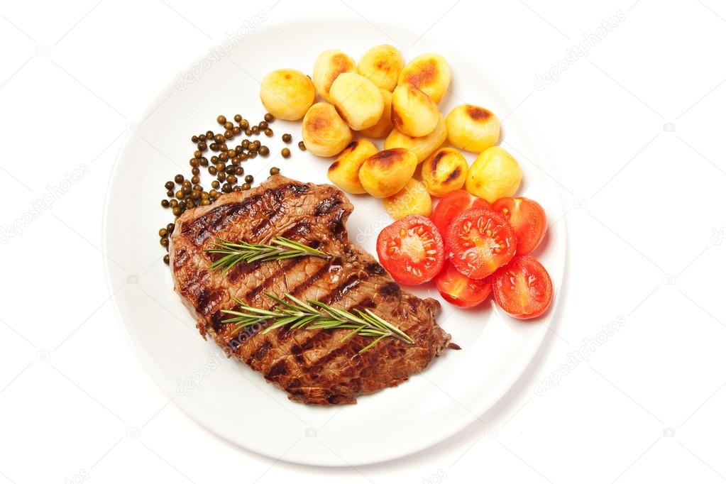 Steak with potatoes and tomatoes