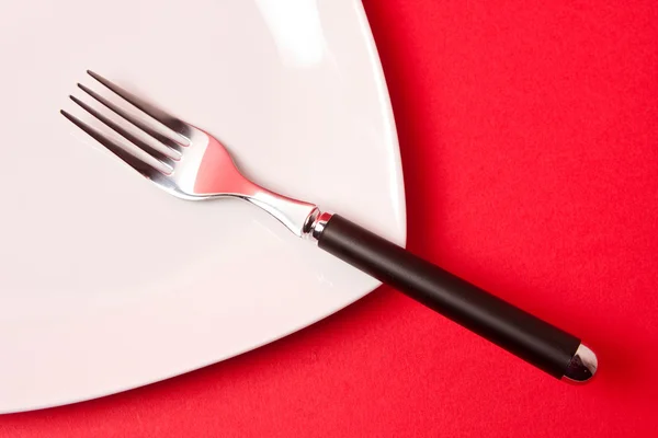 Fork resting on a plate — Stock Photo, Image