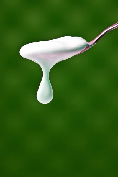 Spoon with yogurt — Stock Photo, Image