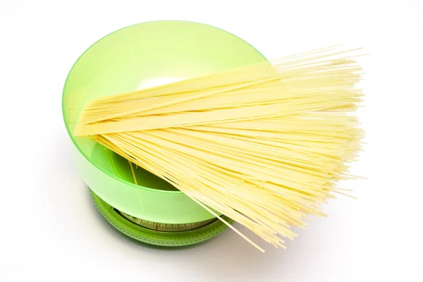 Spaghetti on a kitchen scale — Stock Photo, Image