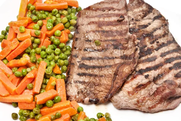 Grilled beef steak served with vegetables — Stock Photo, Image