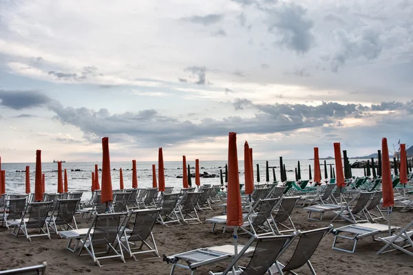 Пляжні парасольки і палуба на заході сонця — стокове фото
