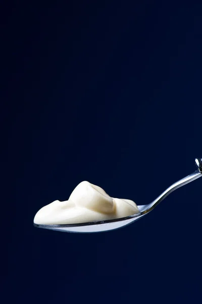 Spoon with yogurt — Stock Photo, Image