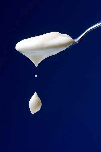 Spoon with yogurt — Stock Photo, Image